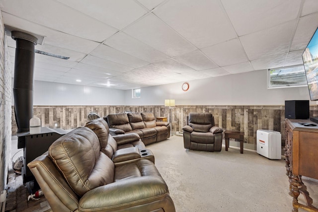 3886 Eagle Rd, Willmar, MN 56201 - living room featuring a wood stove, a wainscoted wall, a paneled ceiling, and wood walls