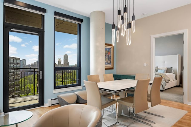 1240 2nd St Unit 1120, Minneapolis, MN 55415 - dining space with baseboard heating, light wood-style floors, and a city view