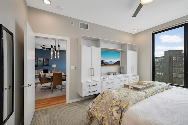 1240 2nd St Unit 1120, Minneapolis, MN 55415 - bedroom with light colored carpet, ceiling fan, and baseboards