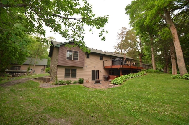 12207 285th St, Lindstrom, MN 55045 - rear view of property featuring a lawn, a wooden deck, and a patio