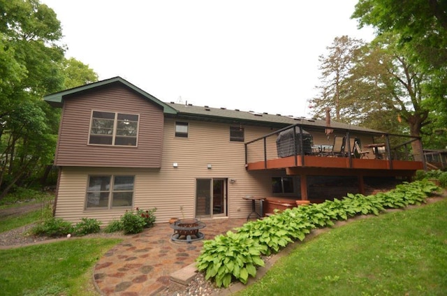 12207 285th St, Lindstrom, MN 55045 - back of property featuring a fire pit, a patio, a wooden deck, and a hot tub