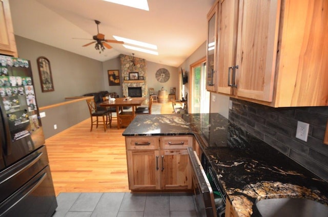 12207 285th St, Lindstrom, MN 55045 - kitchen featuring freestanding refrigerator, a fireplace, vaulted ceiling, a peninsula, and ceiling fan