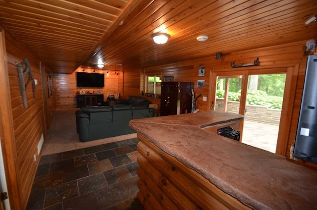 12207 285th St, Lindstrom, MN 55045 - kitchen featuring wooden walls, dark stone finish floors, and wood ceiling