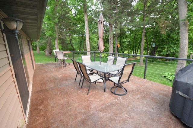 12207 285th St, Lindstrom, MN 55045 - view of patio featuring outdoor dining space, area for grilling, and view of wooded area