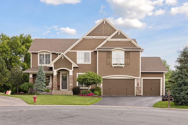 11668 Azure Ct, Inver Grove Heights, MN 55077 - craftsman-style house with a front lawn, driveway, stone siding, and an attached garage