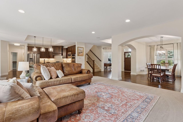 11668 Azure Ct, Inver Grove Heights, MN 55077 - living area with arched walkways, stairs, a tray ceiling, dark wood-style floors, and recessed lighting