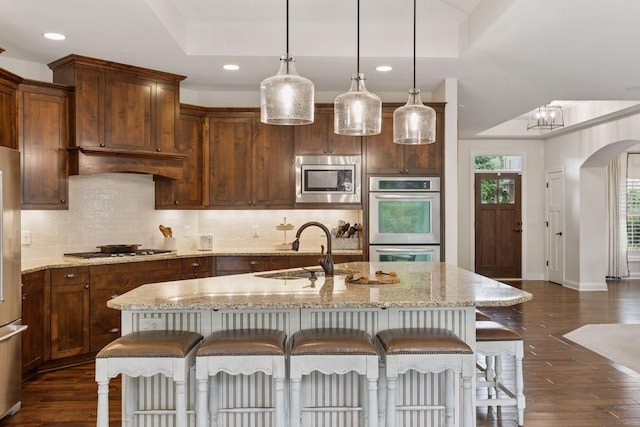 11668 Azure Ct, Inver Grove Heights, MN 55077 - kitchen with stainless steel appliances, a kitchen bar, dark wood finished floors, tasteful backsplash, and recessed lighting