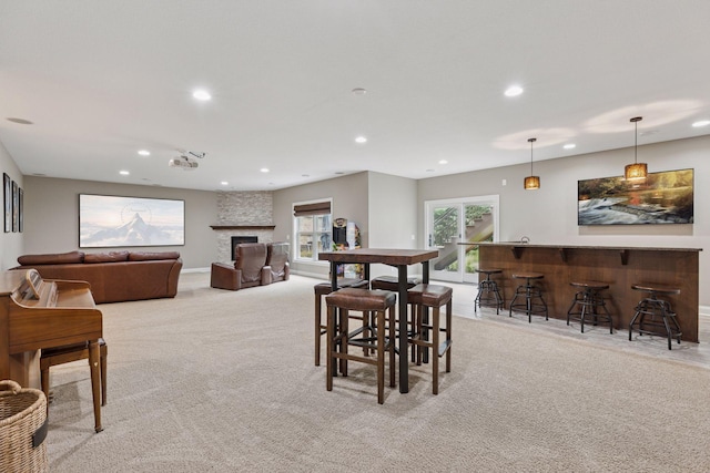 11668 Azure Ct, Inver Grove Heights, MN 55077 - dining space with recessed lighting, a bar, light carpet, and a fireplace