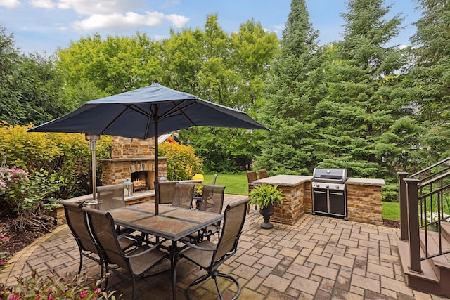 11668 Azure Ct, Inver Grove Heights, MN 55077 - view of patio / terrace with an outdoor stone fireplace, area for grilling, and outdoor dining area
