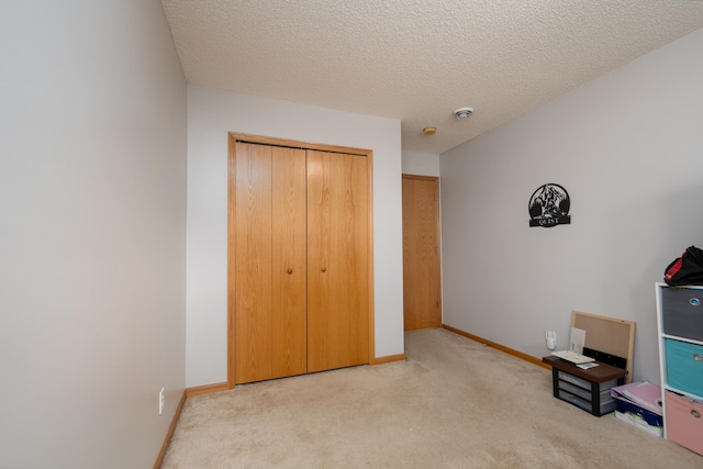 812 Plum Tree Ln, Somerset, WI 54025 - unfurnished bedroom featuring carpet floors, a closet, baseboards, and a textured ceiling