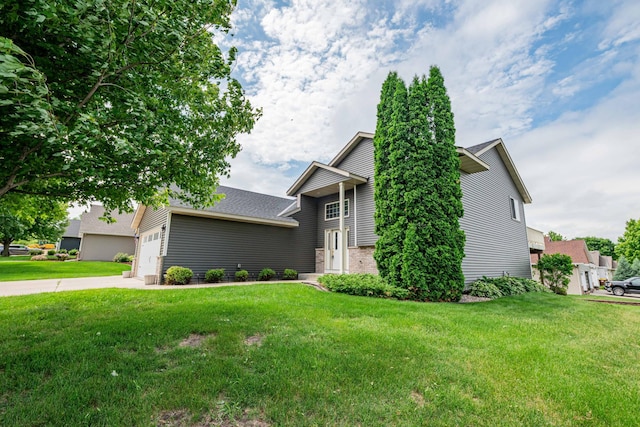 1406 English Ave NW, New Prague, MN 56071 - view of front of house with a front lawn, an attached garage, concrete driveway, and brick siding