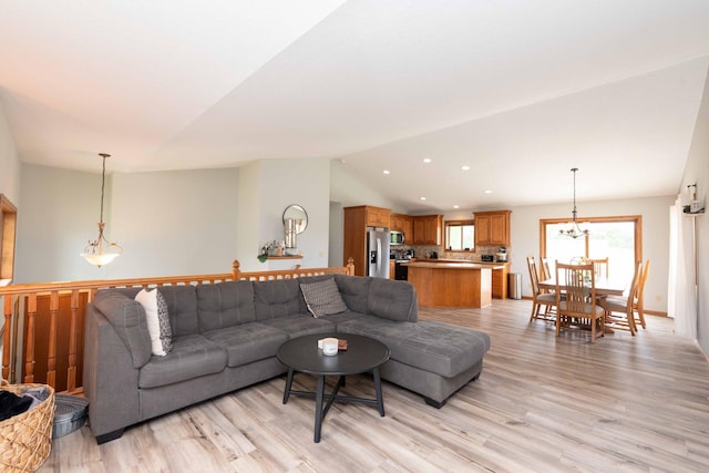 1406 English Ave NW, New Prague, MN 56071 - living area featuring lofted ceiling, a chandelier, light wood-style floors, and recessed lighting