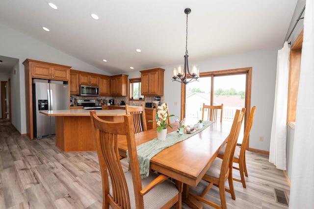 1406 English Ave NW, New Prague, MN 56071 - dining room with vaulted ceiling, light wood-style flooring, a chandelier, recessed lighting, and healthy amount of natural light