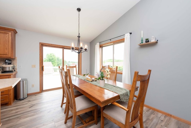1406 English Ave NW, New Prague, MN 56071 - dining room with vaulted ceiling, healthy amount of natural light, a chandelier, and light wood-style floors