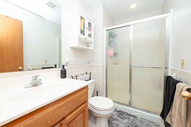 1406 English Ave NW, New Prague, MN 56071 - bathroom with a stall shower, vanity, tile walls, and a wainscoted wall