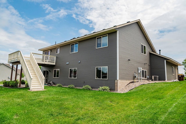 1406 English Ave NW, New Prague, MN 56071 - back of house featuring stairs, a yard, and a wooden deck