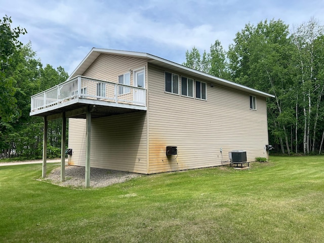 6460 Mountain Maple Ln NW, Walker, MN 56484 - view of side of property featuring central AC unit, a lawn, and a deck