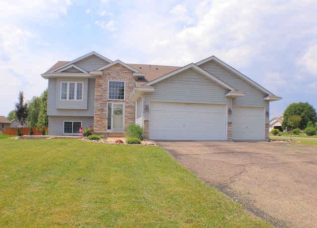 7331 Lamont Ave NE, Otsego, MN 55301 - split level home featuring driveway, stone siding, an attached garage, a front yard, and a shingled roof