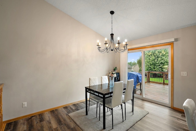 7331 Lamont Ave NE, Otsego, MN 55301 - dining area with a chandelier, wood finished floors, lofted ceiling, and a textured ceiling