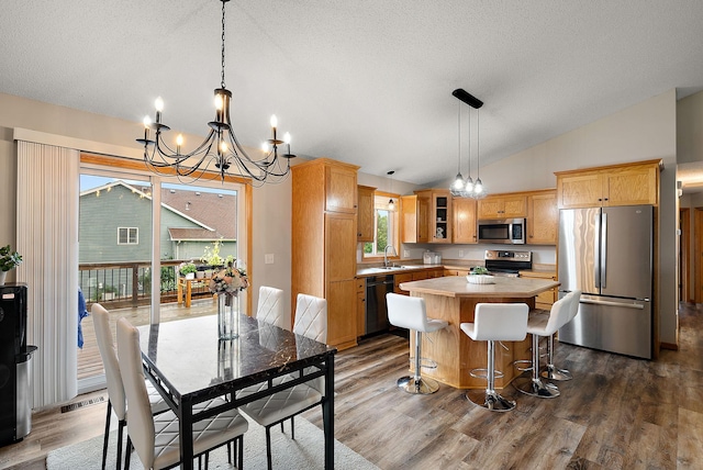 7331 Lamont Ave NE, Otsego, MN 55301 - dining room featuring a chandelier, lofted ceiling, dark wood-type flooring, and a textured ceiling