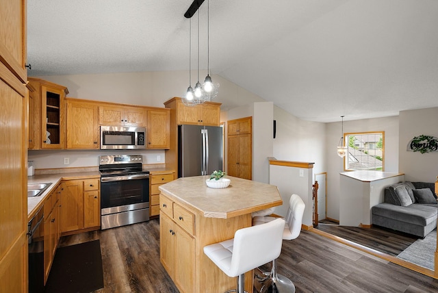 7331 Lamont Ave NE, Otsego, MN 55301 - kitchen featuring appliances with stainless steel finishes, light countertops, vaulted ceiling, a center island, and glass insert cabinets