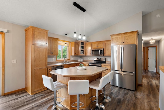 7331 Lamont Ave NE, Otsego, MN 55301 - kitchen featuring stainless steel appliances, vaulted ceiling, dark wood-style floors, a center island, and light countertops