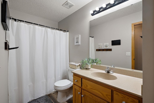 7331 Lamont Ave NE, Otsego, MN 55301 - bathroom featuring a textured ceiling, vanity, and wood finished floors