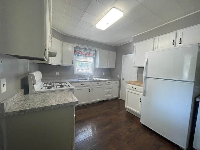810 Charles St, Park Rapids, MN 56470 - kitchen with white appliances, white cabinetry, dark wood-style flooring, and light countertops