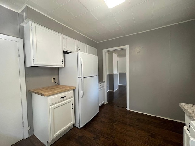 810 Charles St, Park Rapids, MN 56470 - kitchen featuring freestanding refrigerator, white cabinets, dark wood-style floors, and crown molding
