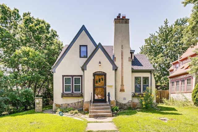 3807 Hubbard Ave N, Robbinsdale, MN 55422 - view of front of home with a chimney, a shingled roof, and stucco siding