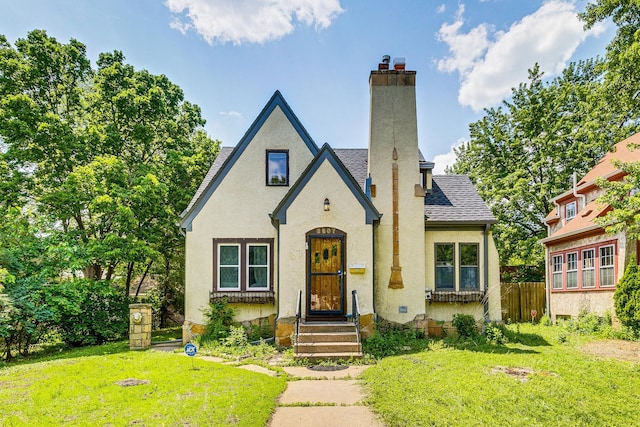 3807 Hubbard Ave N, Robbinsdale, MN 55422 - view of front of house featuring a chimney, stucco siding, and a shingled roof