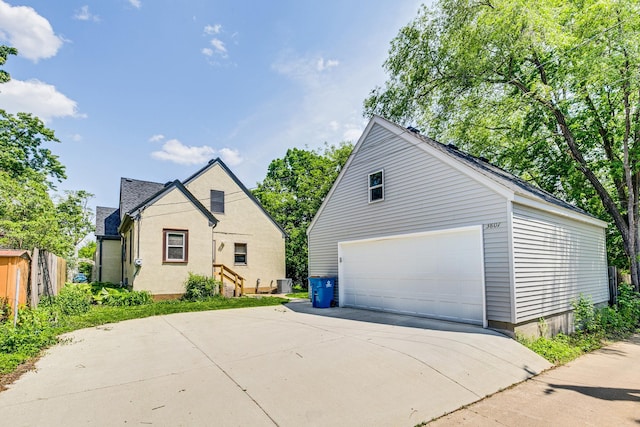 3807 Hubbard Ave N, Robbinsdale, MN 55422 - view of side of home with a detached garage, an outbuilding, and cooling unit