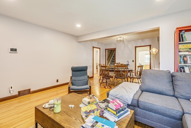 3807 Hubbard Ave N, Robbinsdale, MN 55422 - living area with wood finished floors, recessed lighting, baseboards, and stairway