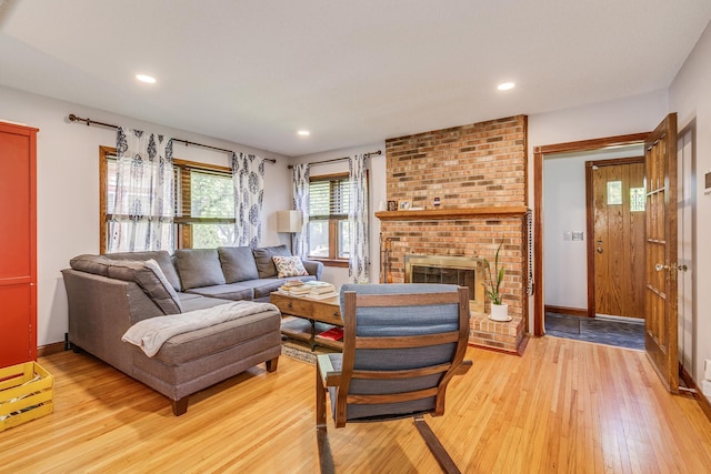 3807 Hubbard Ave N, Robbinsdale, MN 55422 - living area featuring light wood finished floors, baseboards, recessed lighting, and a brick fireplace