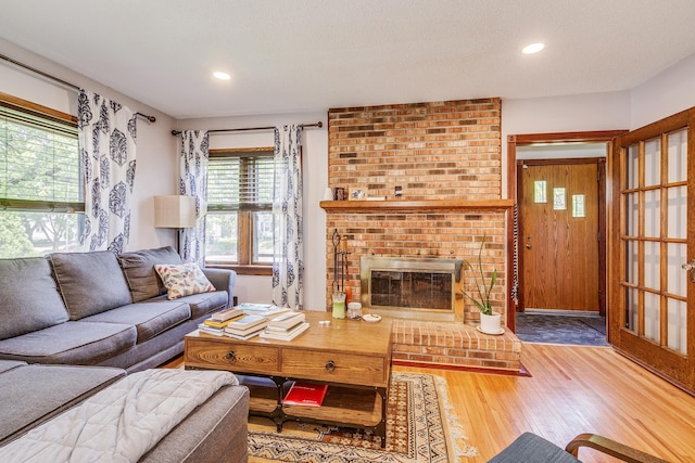 3807 Hubbard Ave N, Robbinsdale, MN 55422 - living room featuring wood finished floors, a fireplace, and recessed lighting