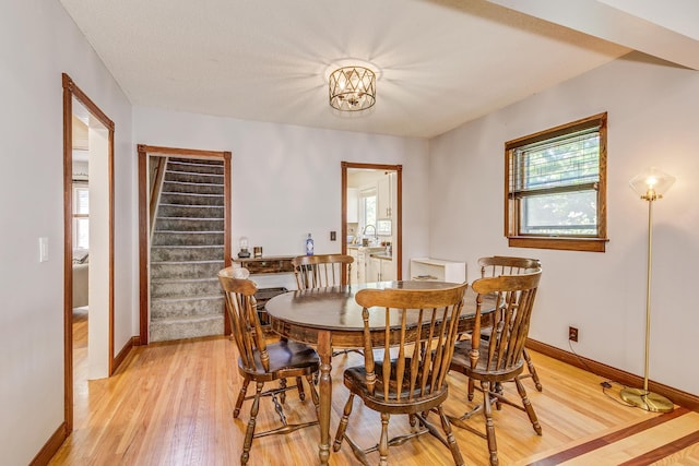 3807 Hubbard Ave N, Robbinsdale, MN 55422 - dining room with stairs, baseboards, and light wood-style flooring