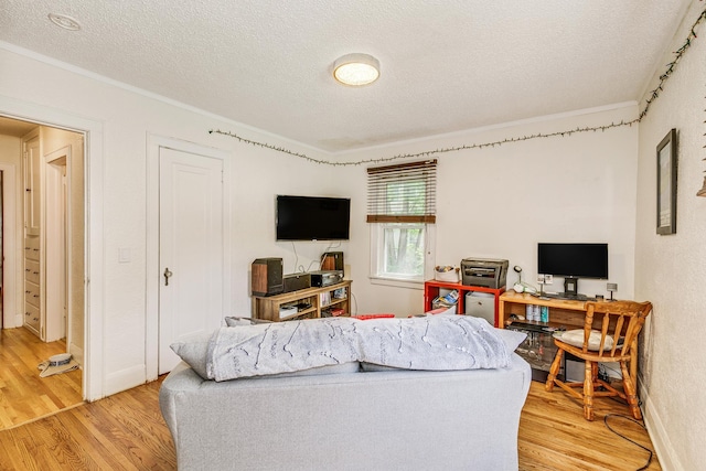 3807 Hubbard Ave N, Robbinsdale, MN 55422 - living area with a textured ceiling, light wood-style flooring, ornamental molding, and a desk