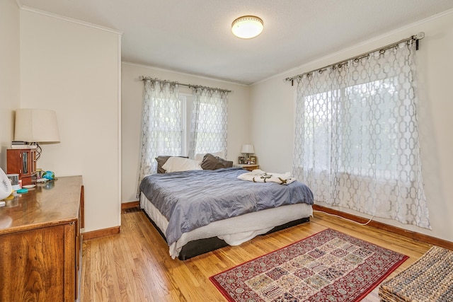 3807 Hubbard Ave N, Robbinsdale, MN 55422 - bedroom featuring crown molding, light wood finished floors, and baseboards