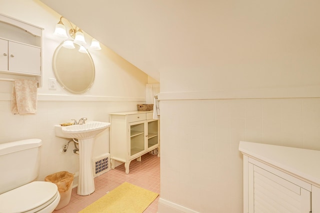 3807 Hubbard Ave N, Robbinsdale, MN 55422 - bathroom featuring toilet, tile walls, and tile patterned floors