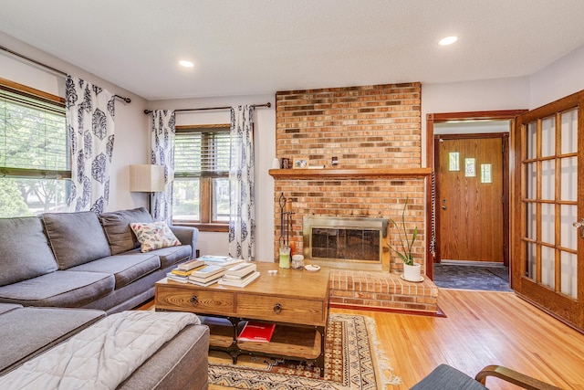 3807 Hubbard Ave N, Robbinsdale, MN 55422 - living area with wood finished floors, a brick fireplace, and recessed lighting