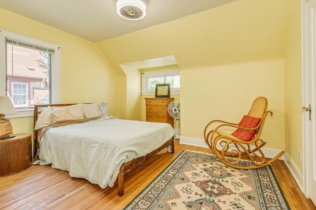 3807 Hubbard Ave N, Robbinsdale, MN 55422 - bedroom featuring light wood-style floors, multiple windows, and vaulted ceiling