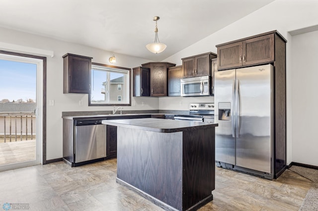 1347 13th St W, West Fargo, ND 58078 - kitchen featuring stainless steel appliances, dark brown cabinetry, lofted ceiling, a kitchen island, and decorative light fixtures