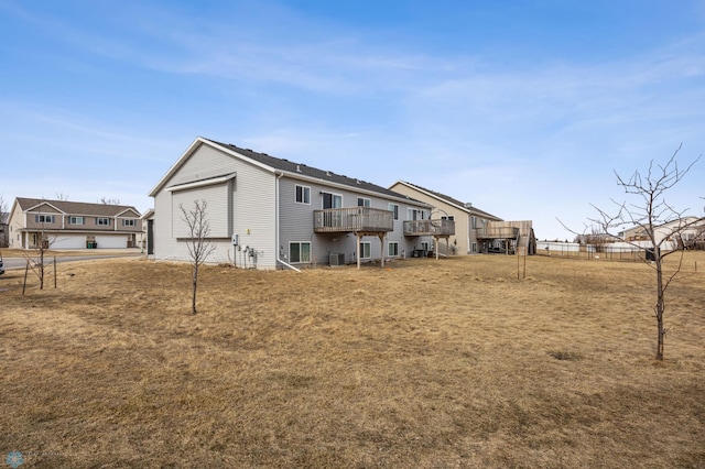 1347 13th St W, West Fargo, ND 58078 - rear view of house featuring a wooden deck, a lawn, and cooling unit