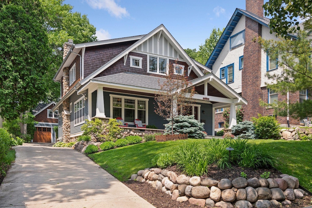 2100 Irving Ave S, Minneapolis, MN 55405 - view of front of home featuring a chimney, a porch, a front lawn, and an outdoor structure