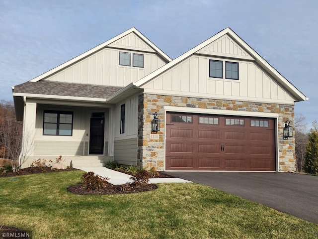 4110 Osprey Ct NE, Prior Lake, MN 55372 - craftsman house with board and batten siding, driveway, roof with shingles, a front yard, and stone siding