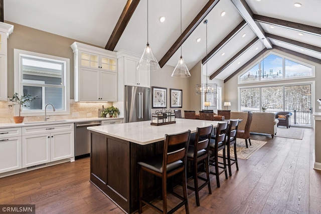 4110 Osprey Ct NE, Prior Lake, MN 55372 - kitchen with appliances with stainless steel finishes, a sink, a center island, recessed lighting, and beamed ceiling