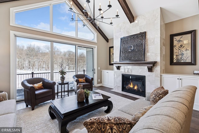 4110 Osprey Ct NE, Prior Lake, MN 55372 - living room with a high end fireplace, wood finished floors, a chandelier, beamed ceiling, and high vaulted ceiling