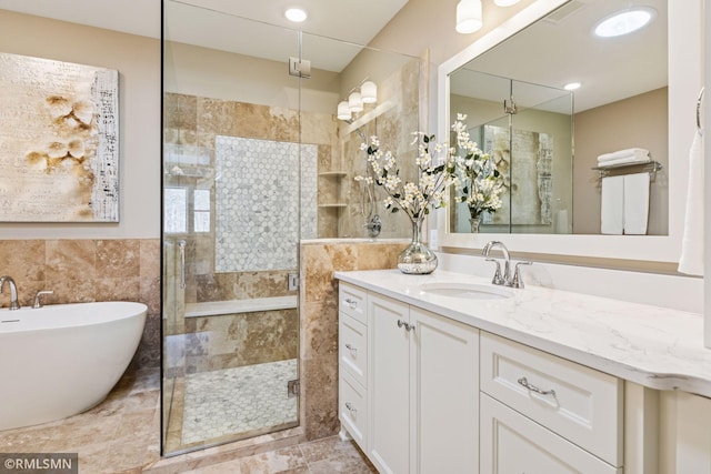 4110 Osprey Ct NE, Prior Lake, MN 55372 - bathroom with a stall shower, a freestanding tub, vanity, and tile walls
