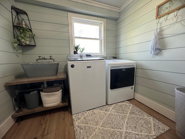 8339 71st St, West Concord, MN 55985 - washroom featuring washer and dryer, light wood finished floors, and wood walls