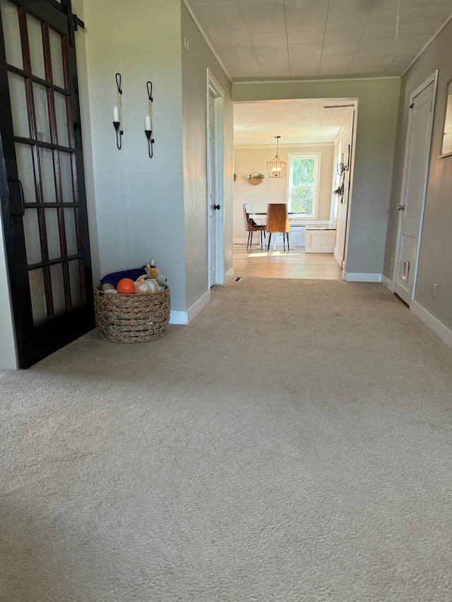 8339 71st St, West Concord, MN 55985 - hallway featuring carpet floors, a chandelier, and baseboards